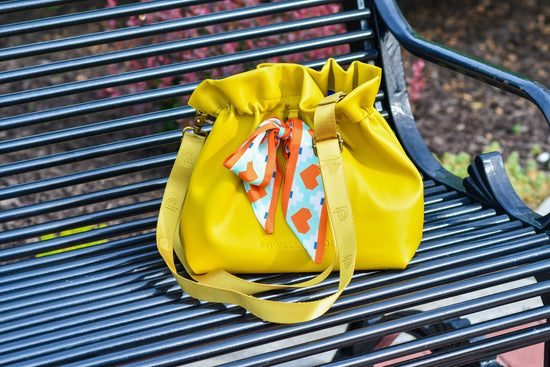 The year round yellow crossbody that can go from day to night with is multi-purpose straps.